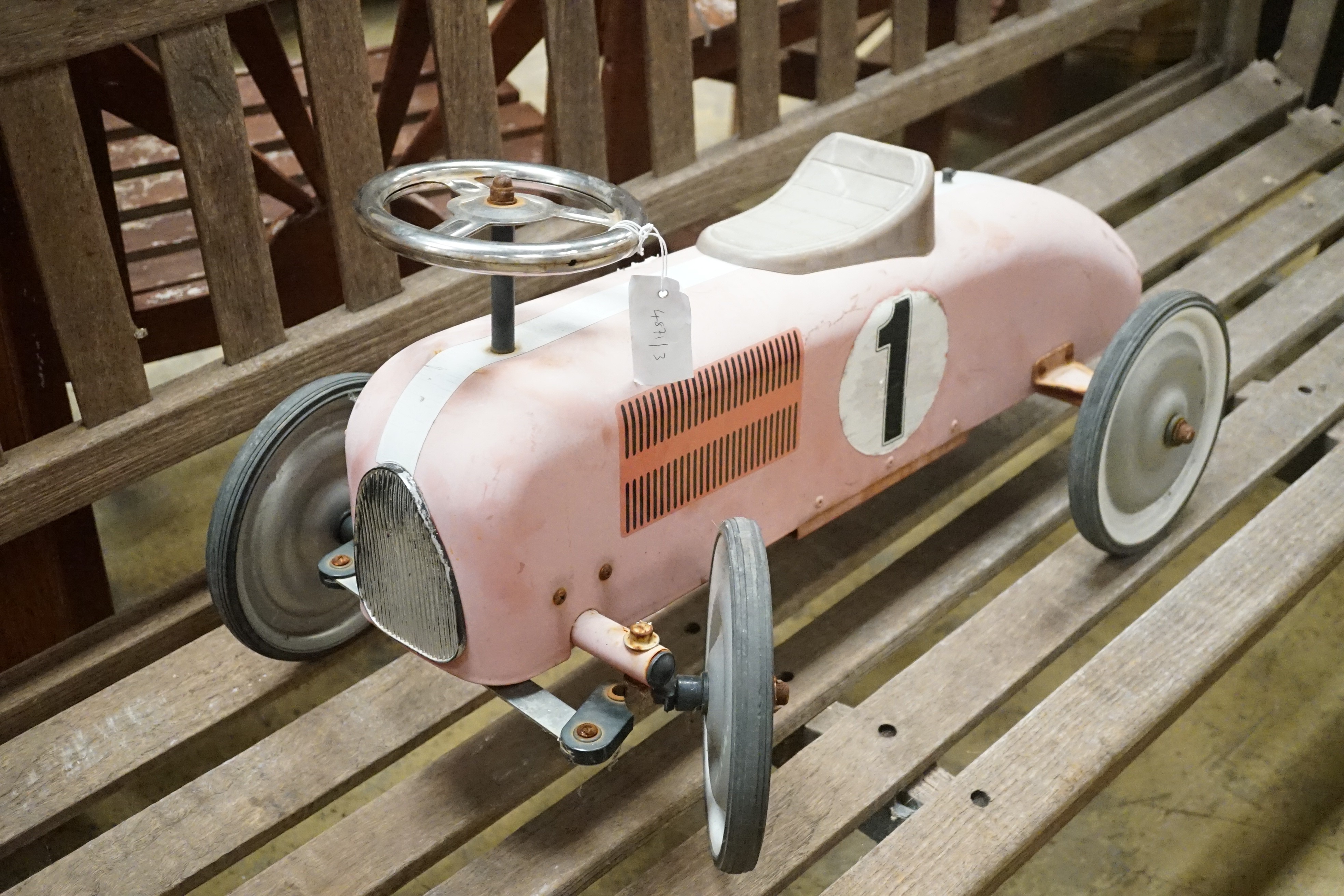 A child's sit-on toy racing car